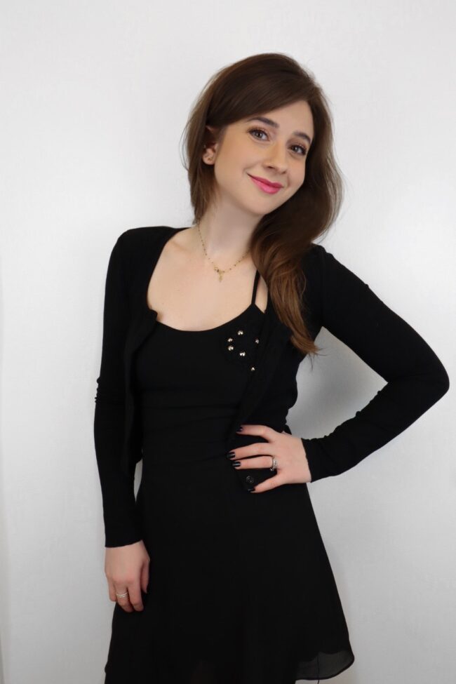 Woman in black dress and cardigan.