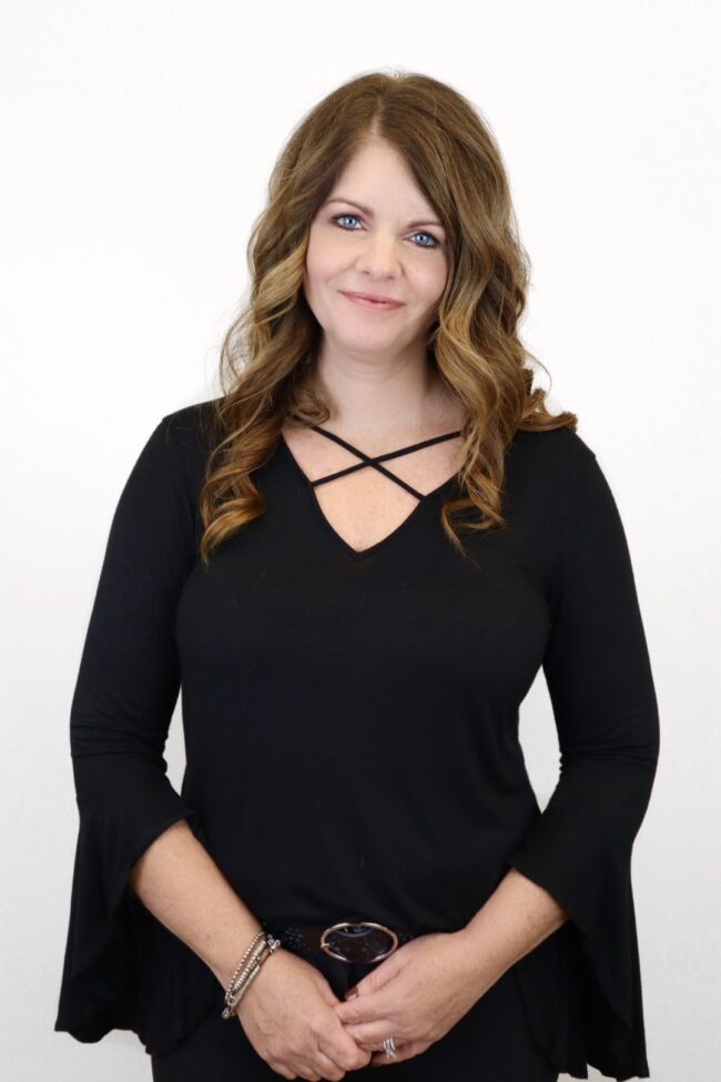 ASHLEY, SALON MANAGER in a black dress