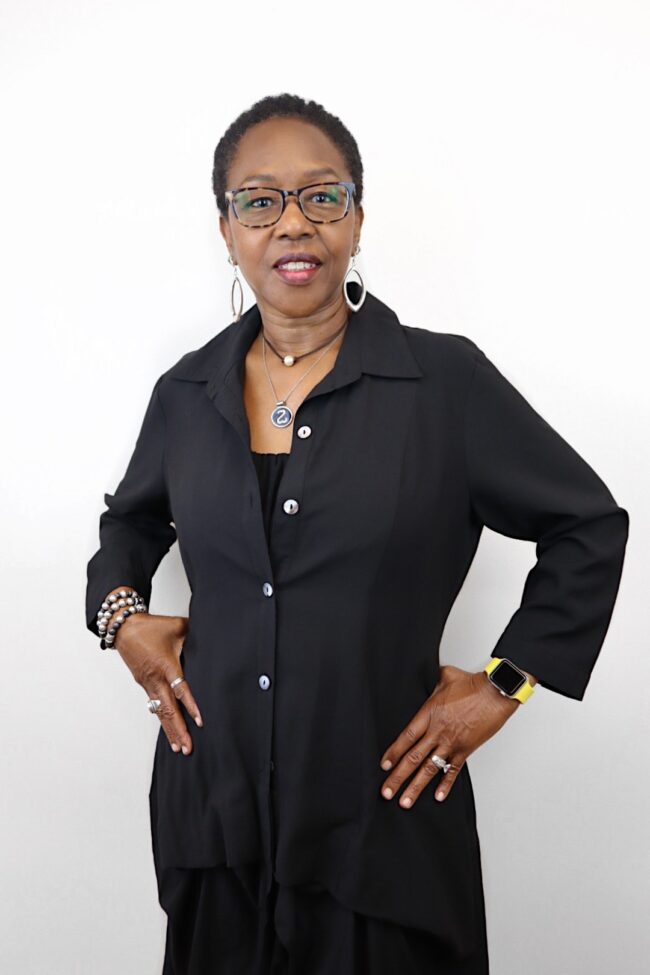 Woman in black shirt and glasses.