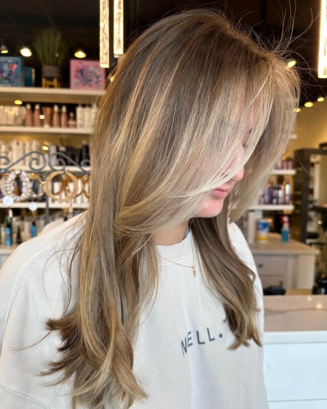 Long blonde hair, stylish highlights.