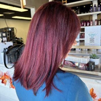 Here's an alt tag for the image: Woman's shoulder-length burgundy hair.