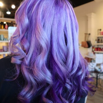 Woman's wavy purple and lavender hair.