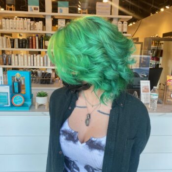 Woman with vibrant green hair.